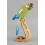 Swarovski  Paradise birds Green Rosella, No. 901601,  yellow in colour and perched on a wooden