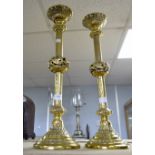 A pair of ecclesiastical brass candlesticks