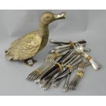 A silver plated duck and a collection of silver plated cutlery