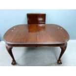 Mahogany extending dining table on carved legs to ball and claw feet (one additional leaf)Heavily