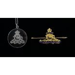 Silver and tortoiseshell Royal Artillery pendant and a gold plated  Royal Artillery brooch,