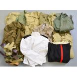 Collection of military uniform items, mostly shirts