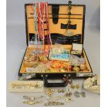 collection of costume jewellery in a brief case including paste set items necklaces and vintage