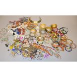 A large quantity of fashion jewellery to include bangles and beads.