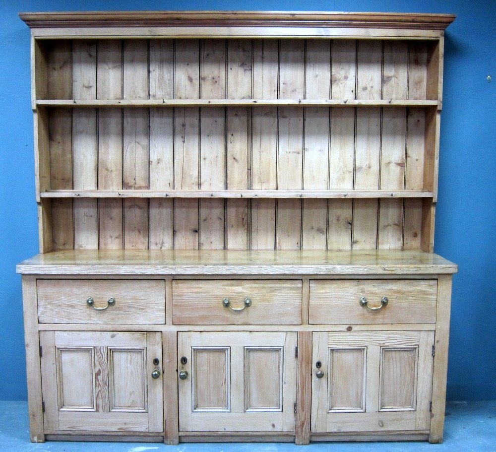 Pine dresser, top with plate rack and hanging hooks, over base with three deep drawers above