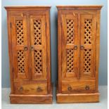 Pair of Hardwood cabinets, each with two cupboard doors over single drawer to plinth base, each