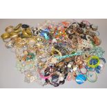 A large quantity of fashion jewellery to include bangles, beads and other items.