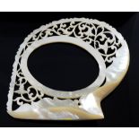 European carved mother-of-pearl shell with pierced decoration with oval aperture, 10cm x 8cm,
