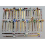 A collection of 19th century and later lace bobbins in bone and turned wood, with glass beads,