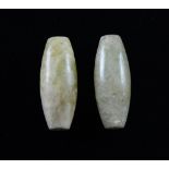 Two Chinese carved hardstone beads of elongated ovoid form, each 3.5cm long,Wear.Natural