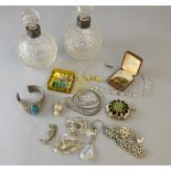 A pair of hobnail but glass perfume bottles with silver mounts and a small collection of costume