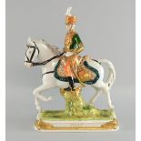 Dresden figure of a cavalry officer in green jacket on horseback, titled 'Pully'.  30cm high.Chip to
