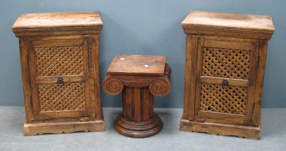 Pair of hardwood cabinets with single pierced doors, each 66cm x 49cm x 31cm and a pedestal in the