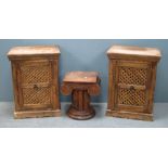 Pair of hardwood cabinets with single pierced doors, each 66cm x 49cm x 31cm and a pedestal in the