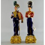 Naples porcelain figure of a military officer in blue uniform carrying red jacket 33cm high and