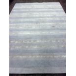 Calvin Klein carpet with blues and silver bands, 131cm x 236cmDirty overall, wear to the edges.