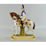 Dresden figure of a military officer in blue and white uniform on a horse.  29cm high.no obvious