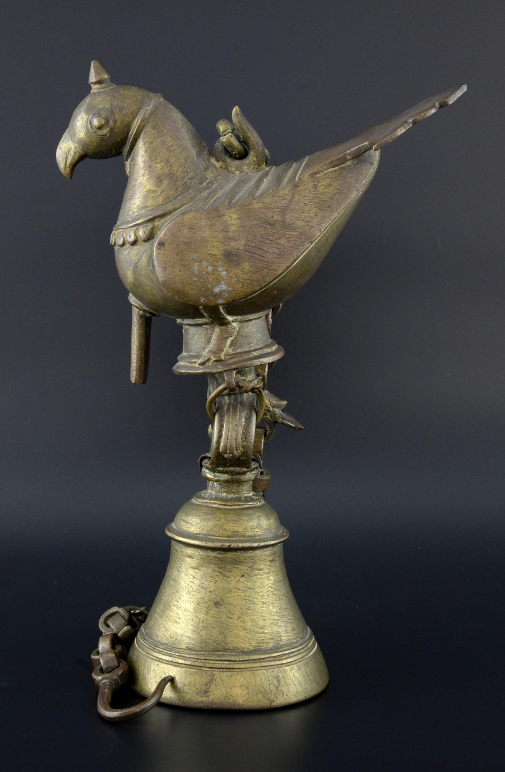 Indian brass hanging bell with bird surmount, 30cm high,