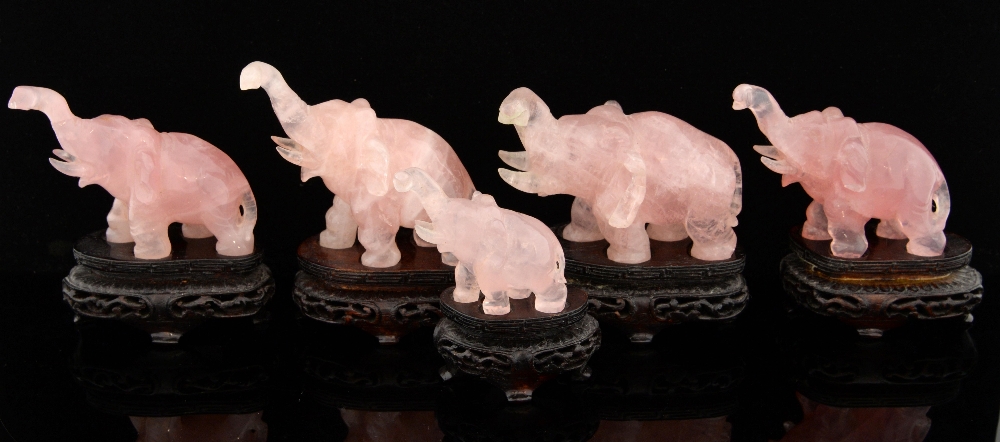 Set of five Chinese carved rose quartz elephants, on hardwood bases, tallest 9cm high,