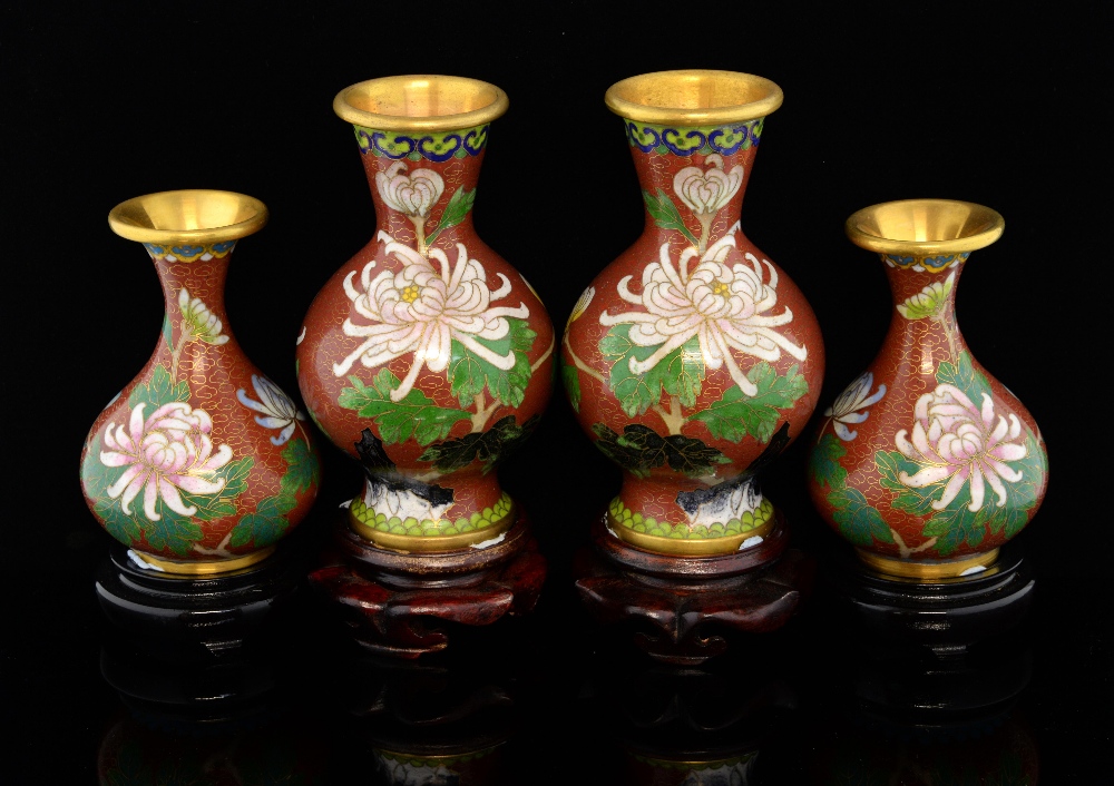 Two pairs of modern Chinese cloisonne vases with brick red grounds and decorated with flowers, on