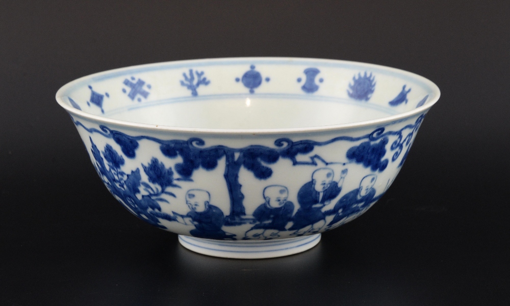 Chinese blue and white bowl decorated with boys playing in a garden, Ming marks but later, 22cm