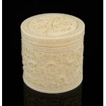 Early 20th century carved ivory cylindrical box and cover carved with dragons amongst clouds, 9cm