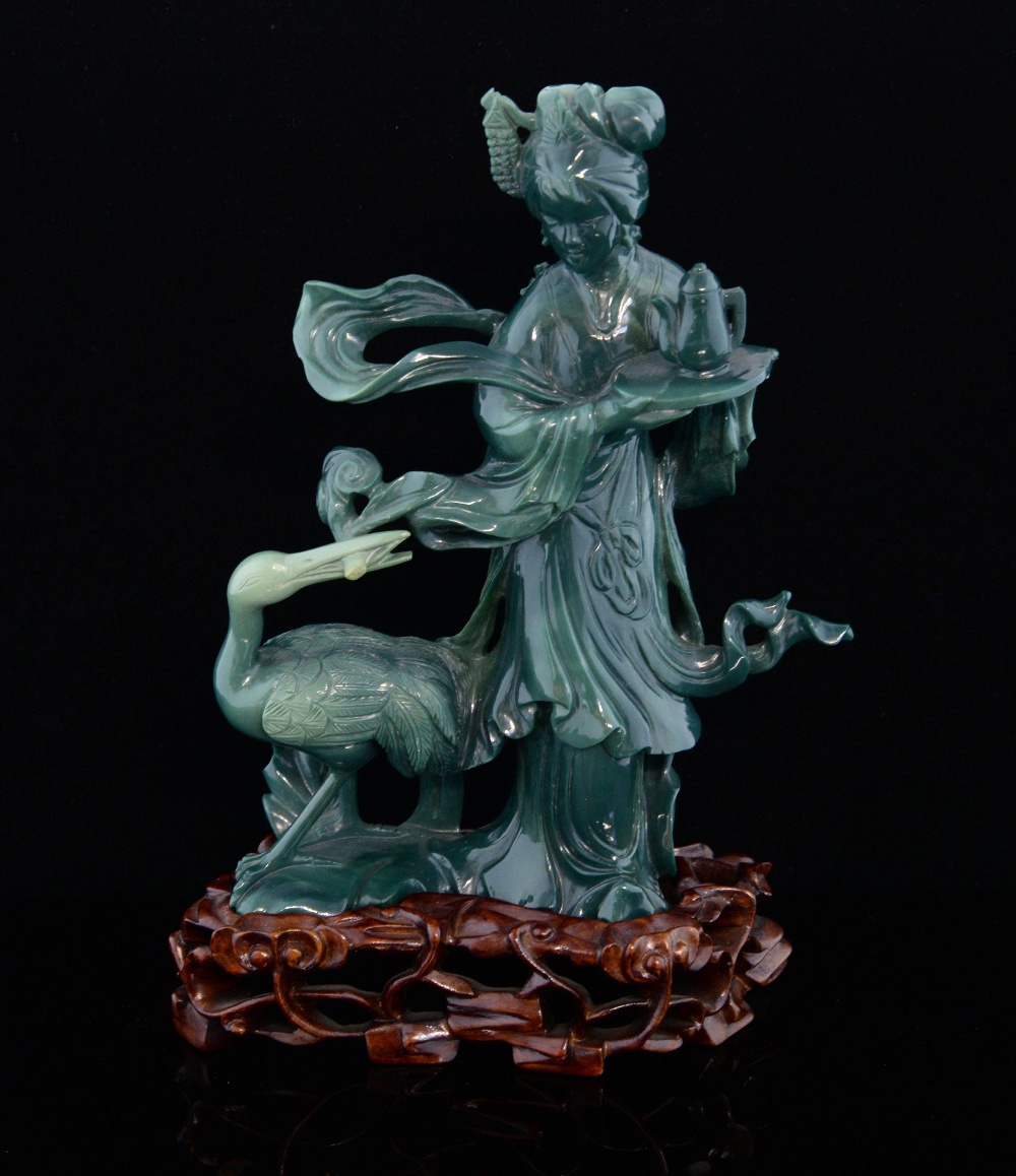 Chinese moulded glass figure of a lady with a tray and teapot and a crane at her feet, on hardwood