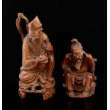 Two Chinese carved hardwood figures of seated robed men on integral naturalistic bases, 23cm high