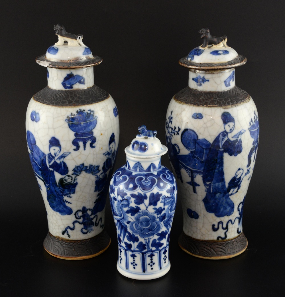 Pair of Chinese crackle glazed blue and white vases decorated with figures and auspicious objects