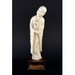 Late 19th/early 20th century Chinese carved ivory figure of a bald man holding a small pot in his