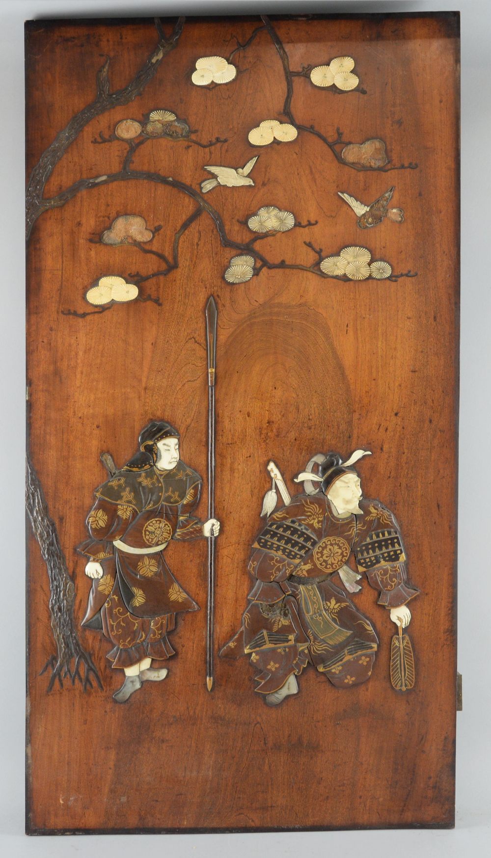 Japanese hardwood panel with overlaid lacquered, ivory and mother of pearl decoration of two Samurai