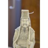 Pair of early 20th century Chinese carved ivory Emperor and Empress figures, he holding a sword, she