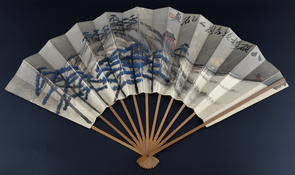 Chinese bamboo and painted paper fan with a landscape scene and a figure travelling towards a