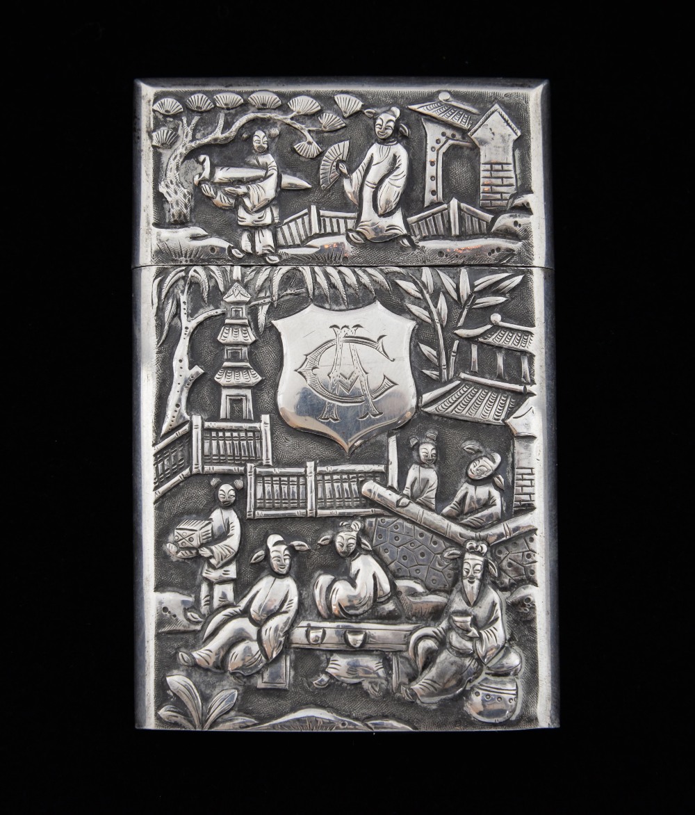 Late 19th/ early 20th century Chinese silver card case with a slip cover, embossed scenes of figures