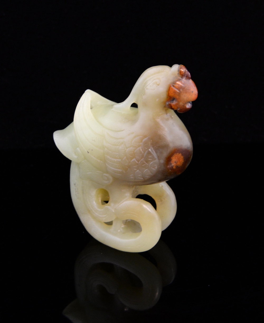 Chinese pale green/yellow jade carving of a  Phoenix, with iron inclusions, the tail curving under