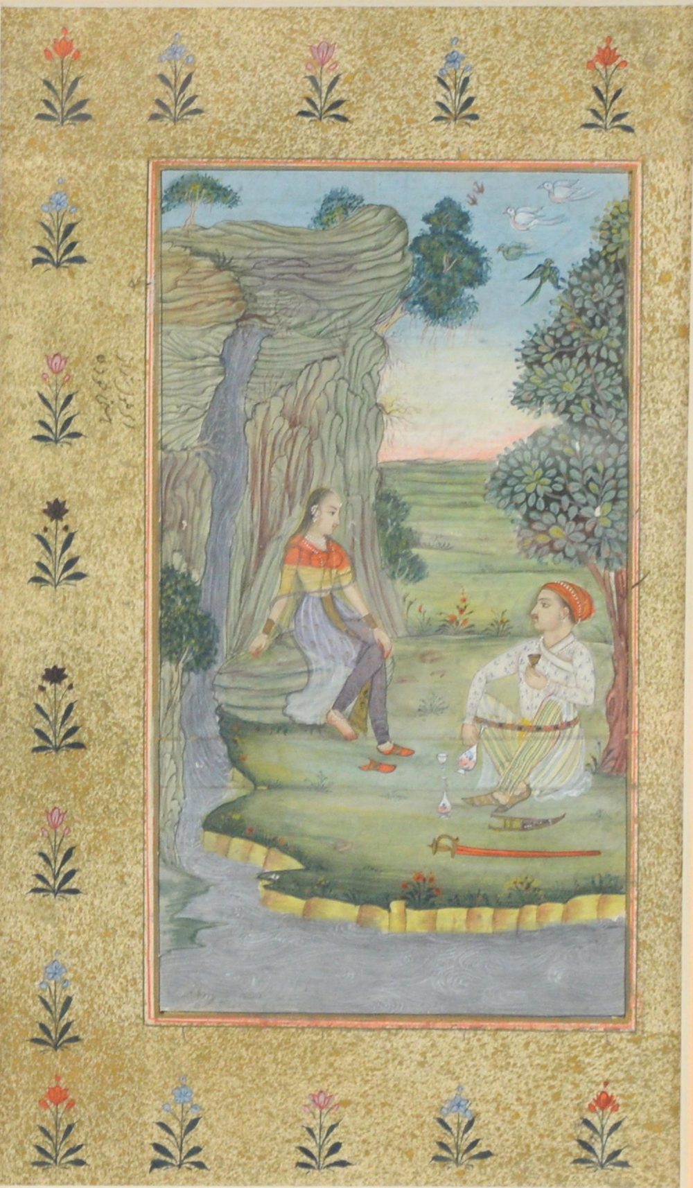 Indian miniature painting depicting a man and woman drinking beside a waterfall, the man's