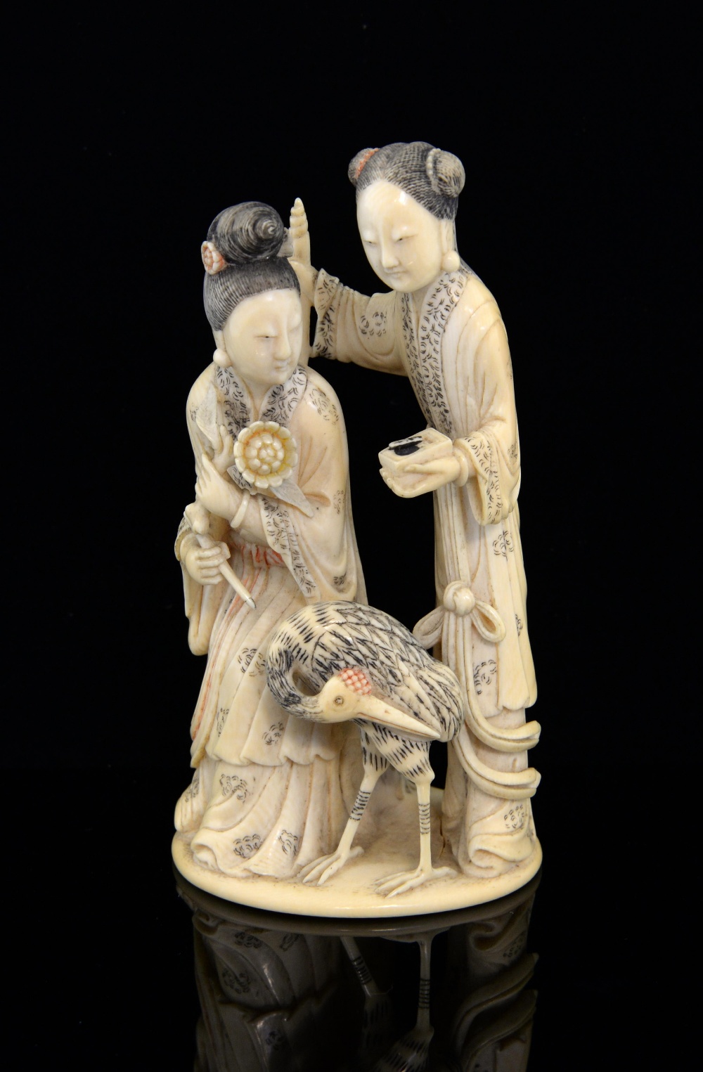 19th century Chinese carved ivory figural group of two ladies holding objects, one standing the