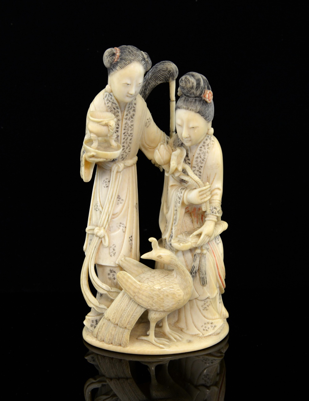 19th century Chinese carved ivory figural group of two ladies, one standing the other seated,