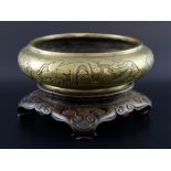 Chinese bronze censer decorated with four panels figures and dragons, on carved hardwood stand, 25cm