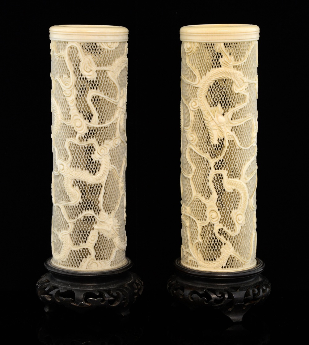 Pair of 19th/early 20th century Chinese Ivory reticulated cylindrical vases carved with dragons on