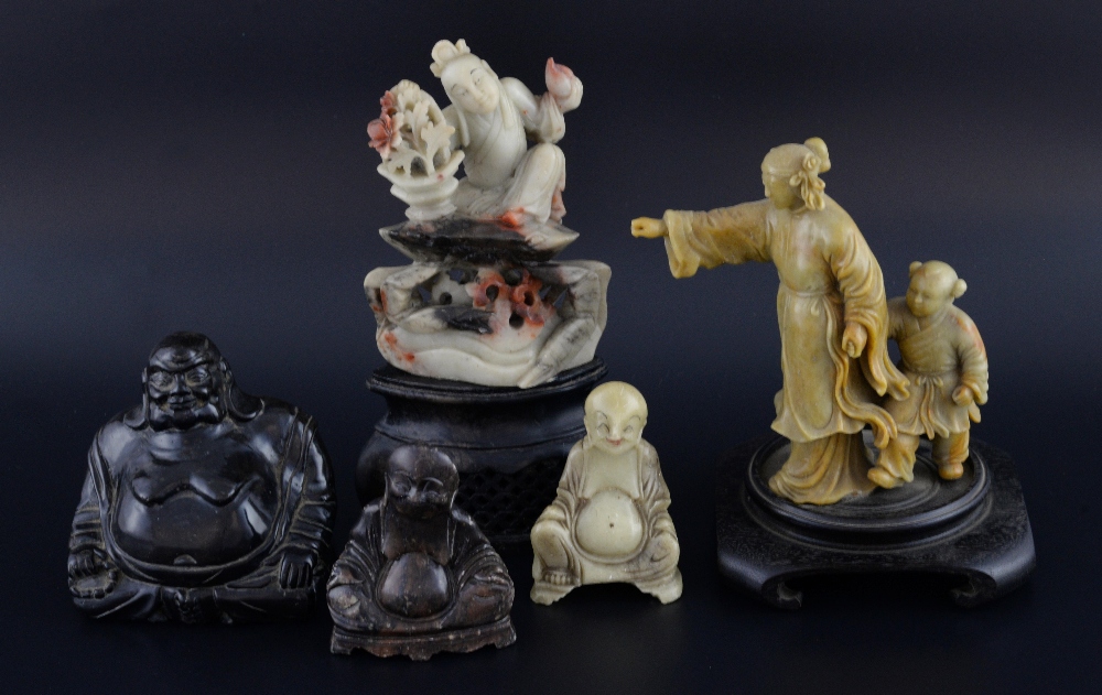 Five Chinese soapstone figures, comprising three figures of Buddha, a figure seated on the back of a