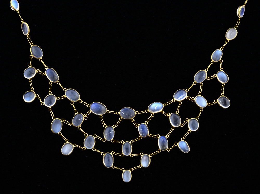 Moonstone and gold fringe necklace, set with oval cabochon-cut moonstones in a rub-over setting.