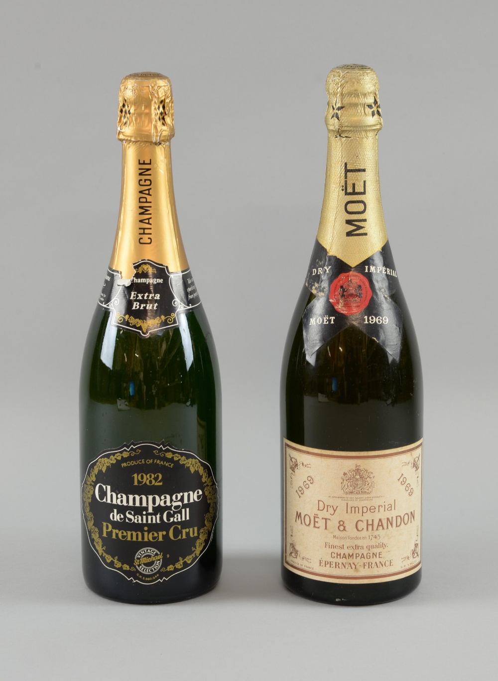 A bottle of Moet & Chandon 1969 vintage dry imperial champagne, and a bottle of Champagne de Saint