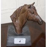 Bronze effect model of a jockey riding a race horse by Heredities and a bronze effect bust of a
