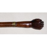 Vintage walking cane with carved handle - a hand holding a ball,