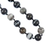 A banded agate bead necklace, comprising a strand of thirty-three spherical banded agate beads,
