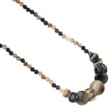 An agate necklace, the front designed as a series of circular-shape graduated panels, to the bead