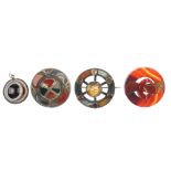 Four Scottish agate brooches, all of circular outline, the first with central buckle design, the