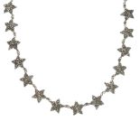 A late 19th century cut steel necklace, comprising a series of pave-set cut-steel stars, with cut-