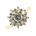 An 18ct gold diamond cluster ring. The brilliant-cut diamond, within a similarly cut diamond